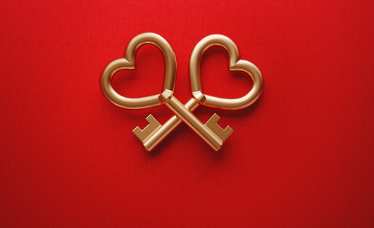 Gold colored heart shaped key pair forming concierge symbol on red background. Horizontal composition with copy space. Concierge concept.