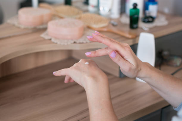 istock Women is applying moisturizer to her hand 1213338872