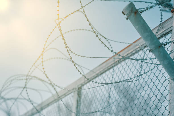 istock border fence with barbed wire 1213340166