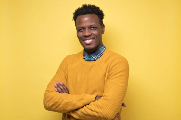 istock Young handsome african business man posing isolated over yellow wall 1213343470