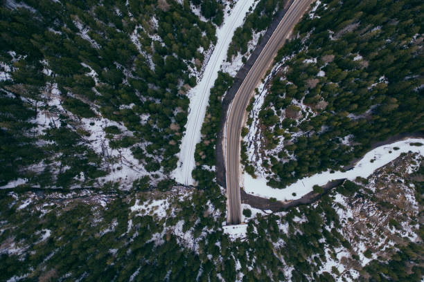 istock road in snow covered forest, top down aerial view 1213346254