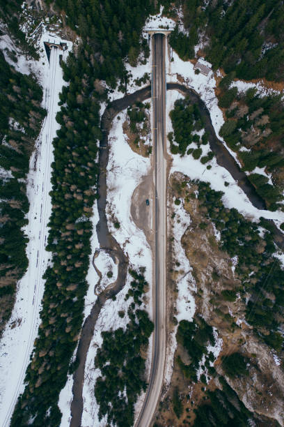 istock road in snow covered forest, top down aerial view 1213346280