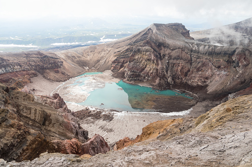 Gorely Volcano, Kamchatka Peninsula, Russia. An active volcano located in the south of Kamchatka. It consists of 11 cones and about 30 craters. Some craters are filled with acid or fresh water.