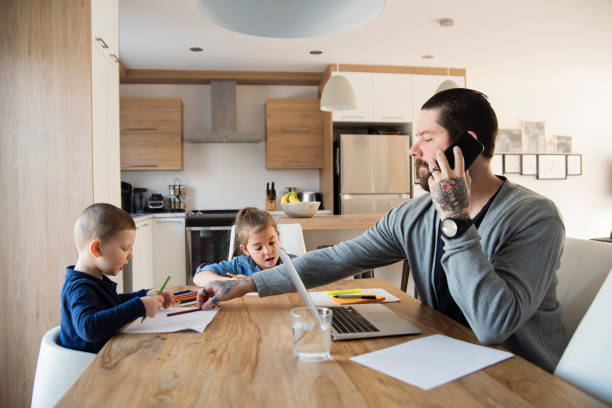Father working from home with young children in quarantine isolation Covid-19