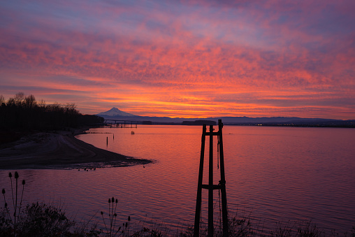 A colorful and dramatic sunrise over the Columbia River and Mt Hood