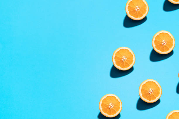 istock Summer abstract trendy fresh concept. Orange pattern on bright light blue background, copy space. Minimal flat lay food texture 1213352132