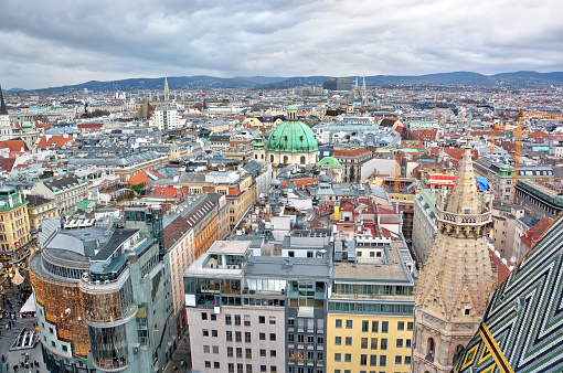 High angle view of Vienna skyline with rooftops and stormy sky in background in Austria, Europe