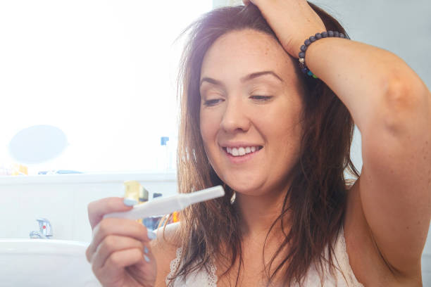 istock Happy woman with positive pregnancy test 1213364539