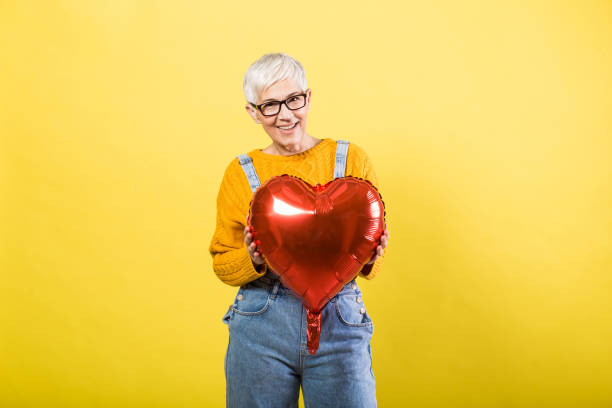 istock Charismatic woman holds a balloon 1213371748