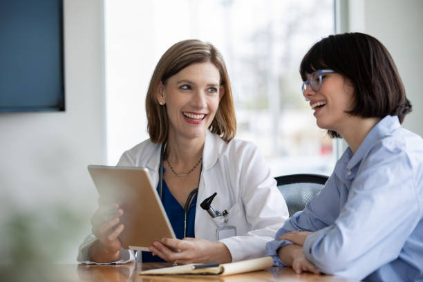 istock Two professional women sitting at conference table 1213371980