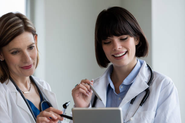 istock Two female doctors discussing medical records 1213372628