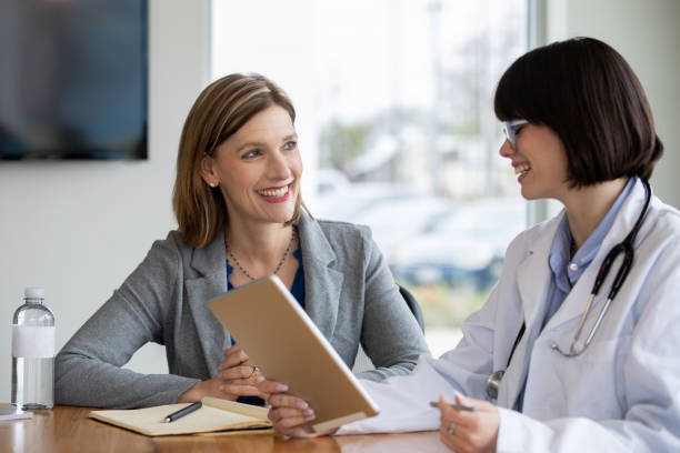 istock Professional women sitting at table in meeting 1213372665