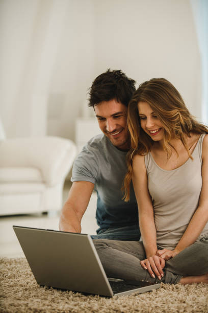 istock Cheerful young couple using laptop together 1213374232