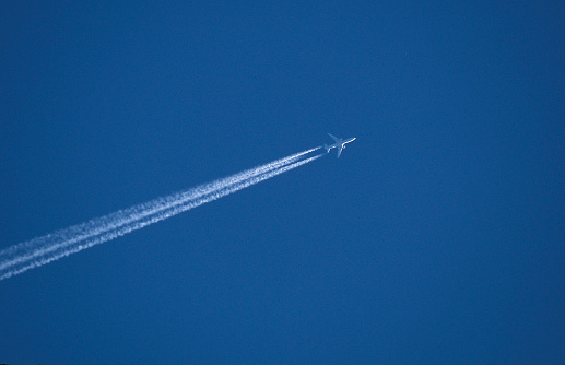 Jet aeroplane condensation trail against a clear blue sky without cloud, Spain