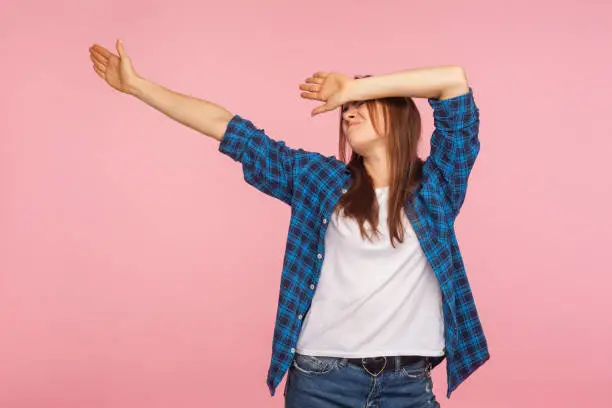Photo of Youth trends. Portrait of woman in checkered shirt showing dab dance move, famous internet gesture of triumph