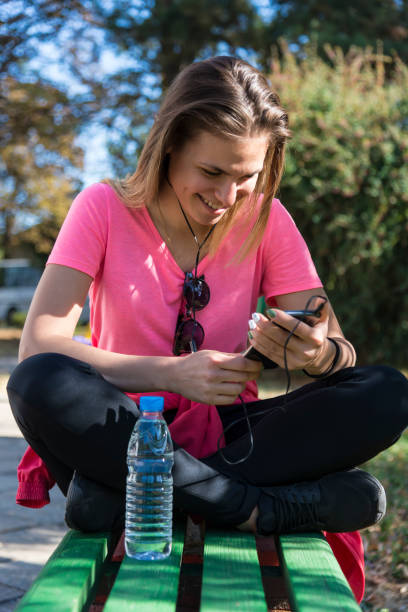 istock Beautiful young woman is training in the park 1213375807