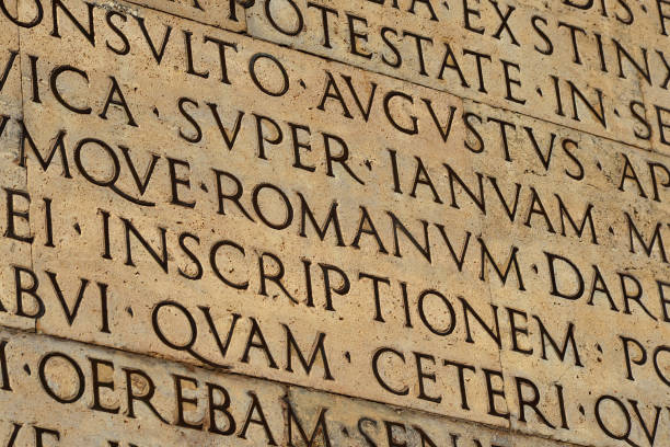 Latin ancient language and classical education Inscription from Emperor Augustus famous Res Gestae (1st century AD), with the word Romanum in the center latin script stock pictures, royalty-free photos & images
