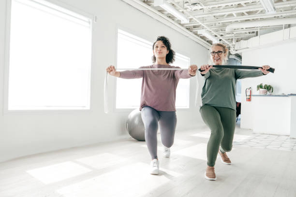 istock Senior women exercising   with physiotherapist 1213376724