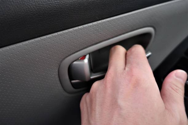 istock Hand opening vehicle door lever 1213384820