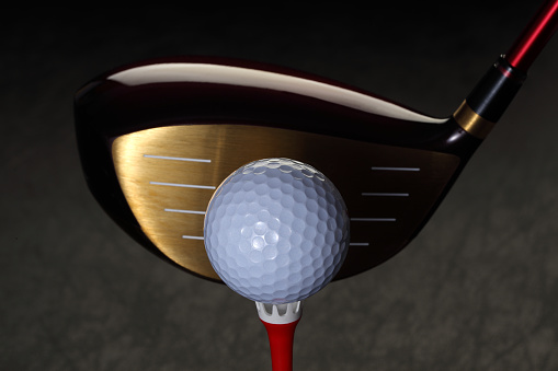 Golf Wood with a Golf Ball and Golf Tee Isolated on Black