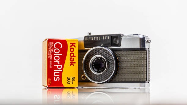picture of  vintage analog film model colorplus 36 exp. 200, 35 mm, in a box, brand new and olympus pen-ee camera, manually camera with half-frame technic, kodak and olympus company logo , illustrative editorial image - manually imagens e fotografias de stock