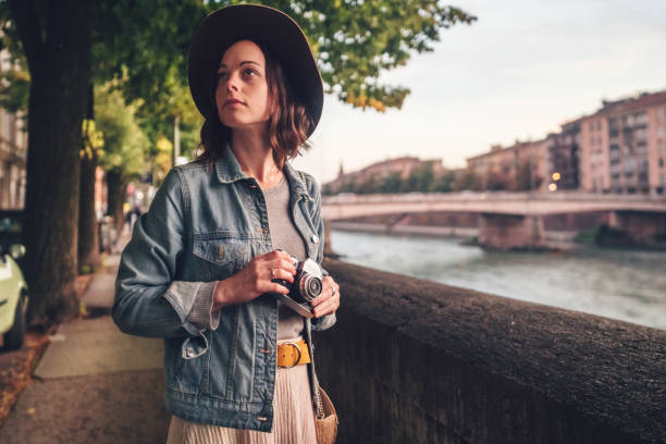 istock Attractive girl with a camera in Italy 1213397522