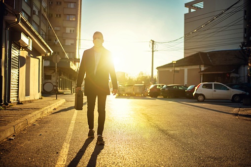 Young adult man going to job wearing anti virus  mask.