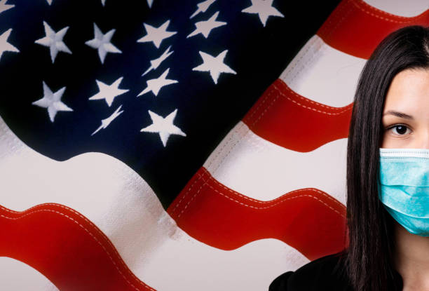 Lady wearing pollution mask. USA flag. Coronavirus concept. stock photo