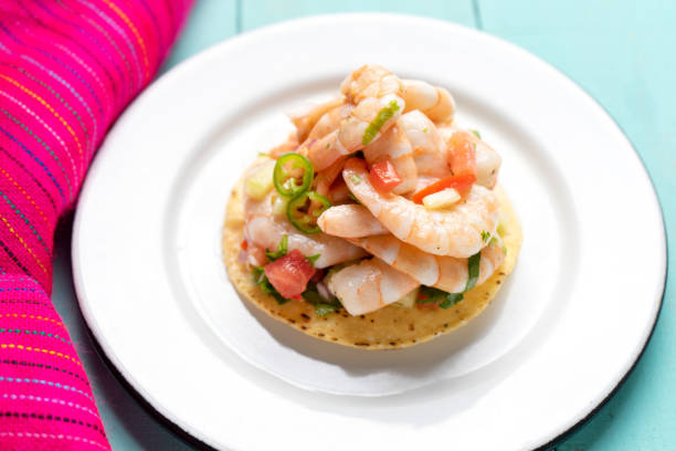 istock Mexican shrimp ceviche toast also called tostada on turquoise background 1213400074