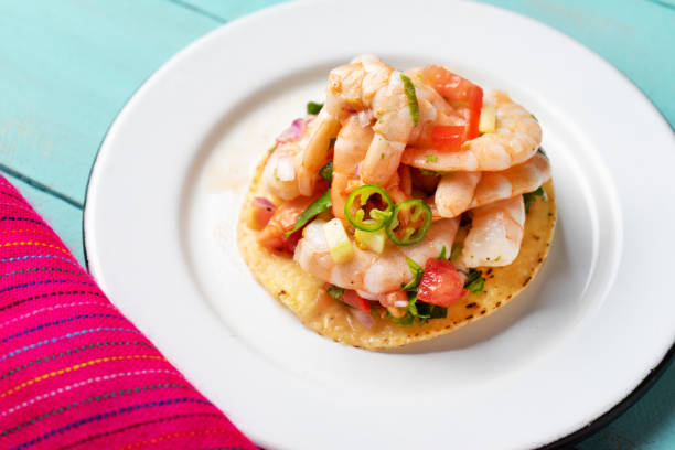 istock Mexican shrimp ceviche toast also called tostada on turquoise background 1213400143