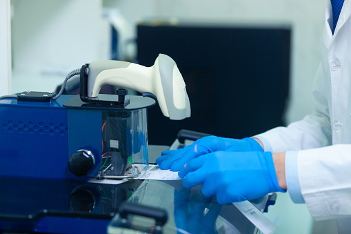 Dna Laboratory The Expert Puts The Human Dna Into The Database Using ...