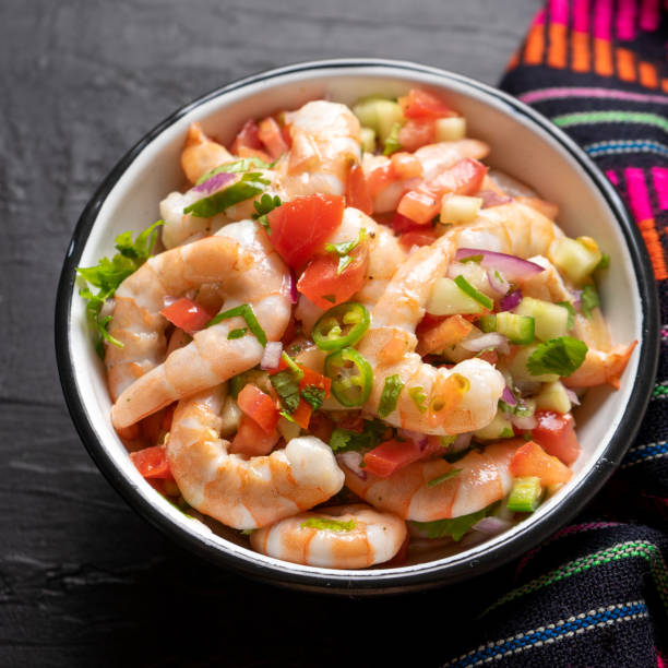 istock Mexican shrimp ceviche with tomato and serrano pepper on black background 1213401196