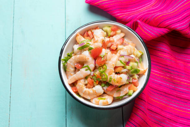 istock Mexican shrimp ceviche with tomato and serrano pepper on turquoise background 1213401258