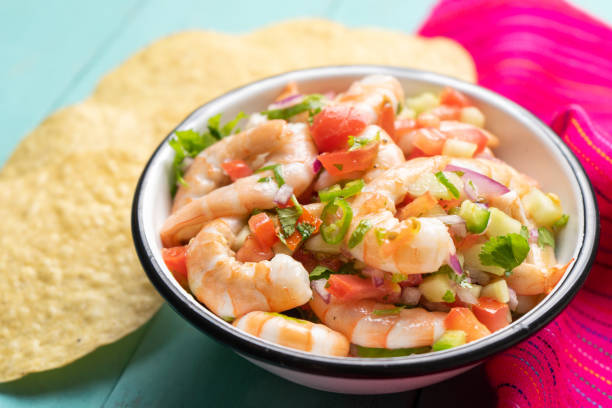 istock Mexican shrimp ceviche with tomato and serrano pepper on turquoise background 1213402123