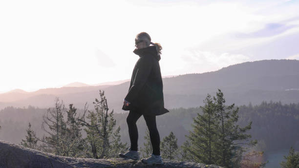 istock Female hiker walks along mountain ridge 1213403068