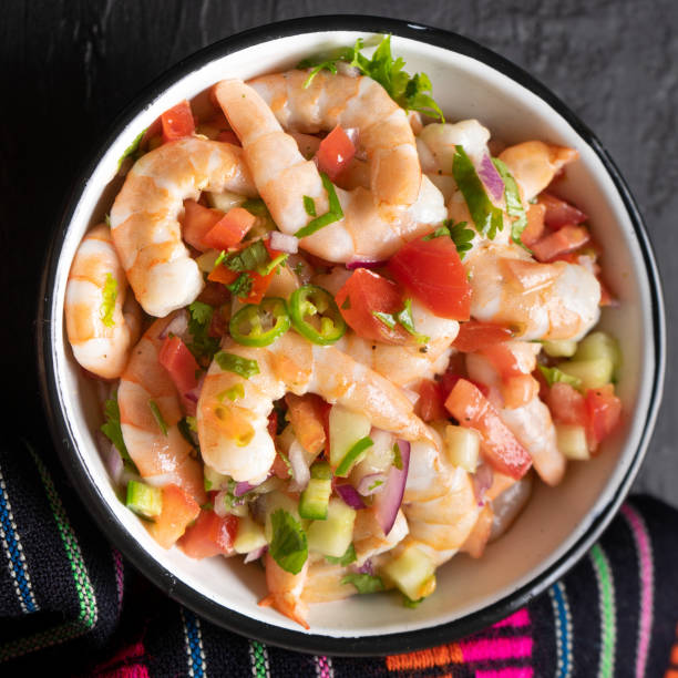 istock Mexican shrimp ceviche with tomato and serrano pepper on black background 1213404247