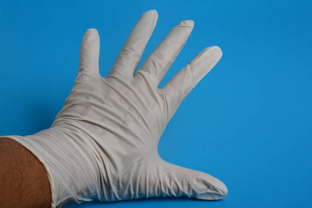 istock glove latex hand examination on blue background 1213404271