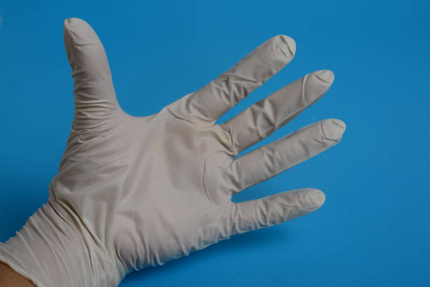 istock glove latex hand examination on blue background 1213404274