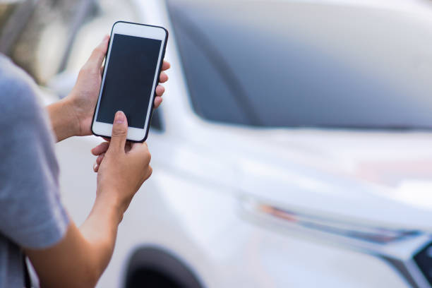 istock Hand holding mobile smart phone application to start car technology smart life 5G 1213407645