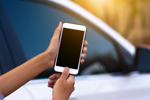 istock Hand holding mobile smart phone application to start car technology smart life 5G 1213407647