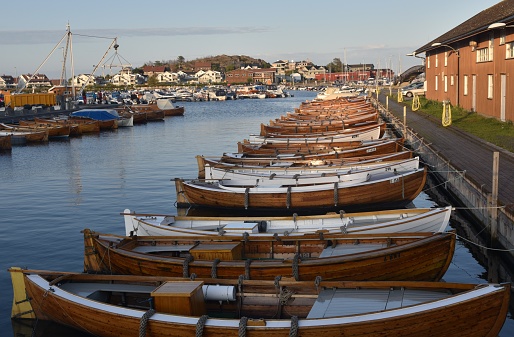 August 2019, Stavern, Norway - Multiple Beautiful wooden boats are lined up in Norwegian town of Stavern showing the connection between land and sea