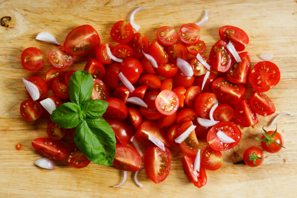 istock red cherry tomato and basil leaf on wooden background 1213414627