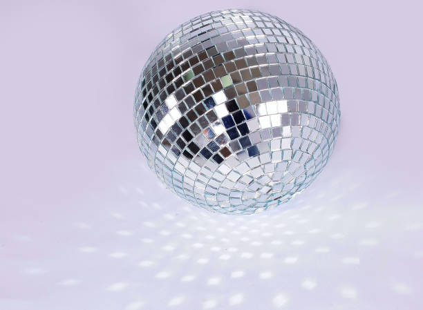 istock beautiful disco ball on yellow background isolated. 1213417164