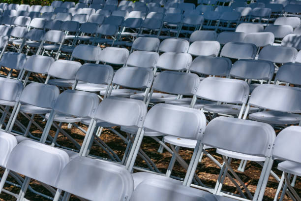 istock White plastic chairs set up an outdoor in a row 1213418661