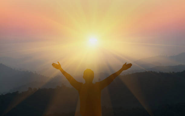 istock The man raised his arm up the mountain. He thanked God. 1213421850