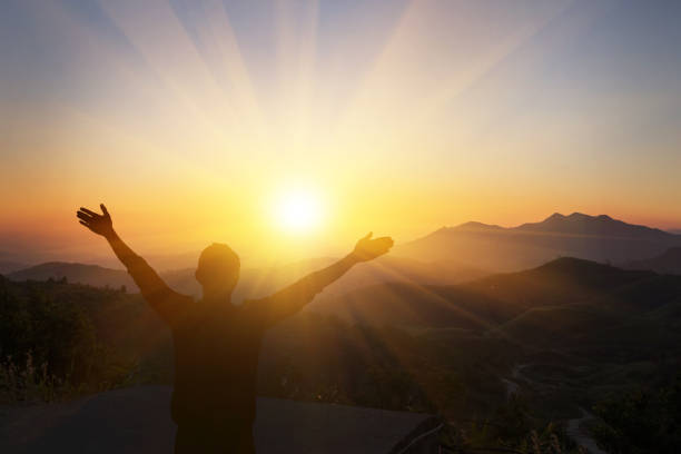 istock The man raised his arm up the mountain. He thanked God. 1213421857