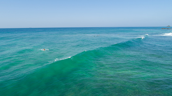 Aerial view from drone of surfers surfing  in the indian ocean