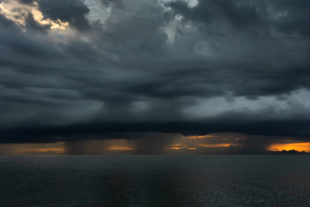 istock Rainfall in the lake with dark clouds on sky. 1213424504