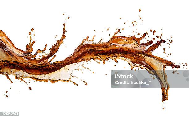 Isolated Image Of Cola Splash Across A White Background Stock Photo - Download Image Now