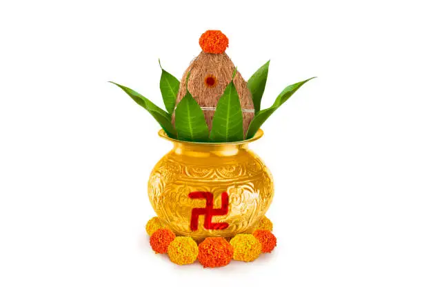 Copper and gold kalash with coconut and mango leaf with marigold flower decoration at the bottom for hindu puja  for all hindu pooja occasions